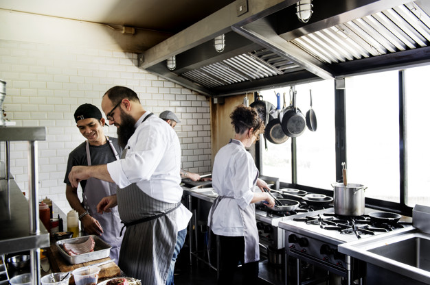 group-chefs-working-kitchen_53876-42734