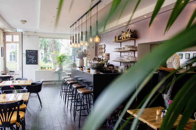 interior-shot-cafe-with-chairs-near-bar-with-wooden-tables_181624-1669